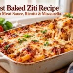 Homemade baked ziti with meat sauce, ricotta cheese, and melted mozzarella in a casserole dish.