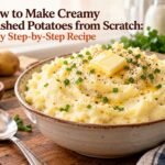 Creamy homemade mashed potatoes with melted butter and fresh chives in a serving bowl.